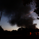 “Light from a light pole shows a house near a plume of smoke from a Colonial Pipeline explosion, Monday, Oct. 31, 2016, in Helena, Ala. - AP”